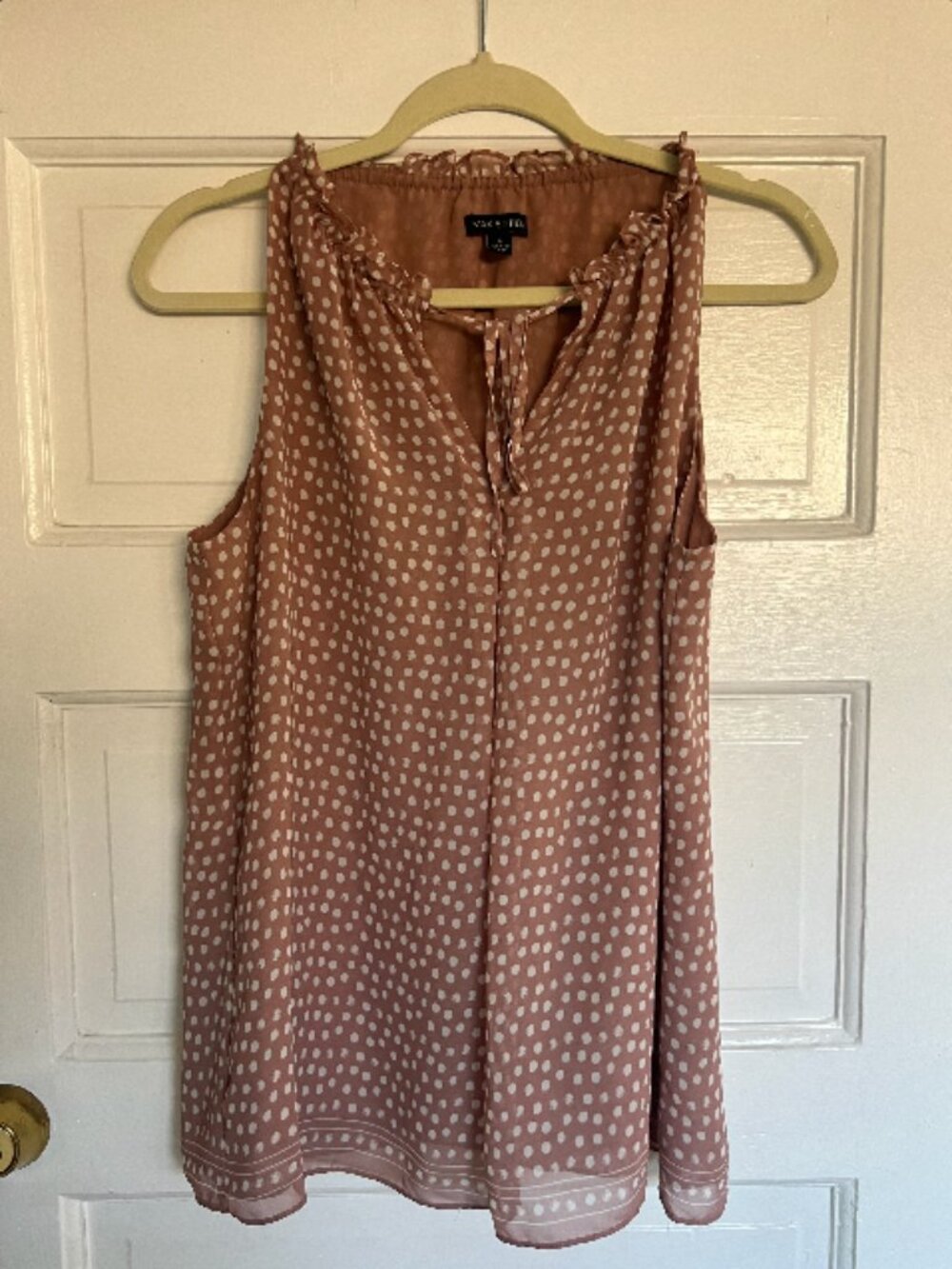 Pink spotted sleeveless tie blouse